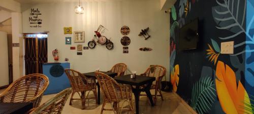 a restaurant with a table and chairs in a room at Passions de Goa in Anjuna