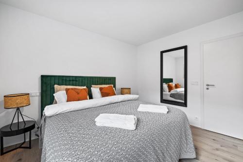a bedroom with a large bed with a mirror at Unwind in Luxury Steps From Smáralind Mall in Reykjavík