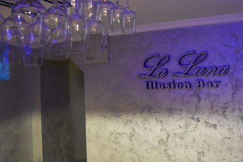 a group of glasses hanging from a wall with a sign at La Luna Rustic Deluxe Apartment with Free Jacuzzi, Bikes & Covered Parking in Našice