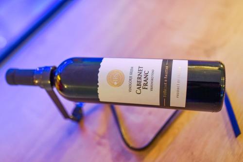 a bottle of wine sitting on top of a table at La Luna Rustic Deluxe Apartment with Free Jacuzzi, Bikes & Covered Parking in Našice