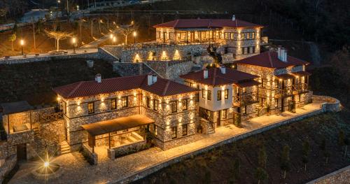 an aerial view of a large mansion at night at Unedo All Seasons Hotel in Palaios Panteleimon