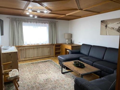 a living room with a couch and a table at Haus Jochbergerstrasse 116 in Kitzbühel