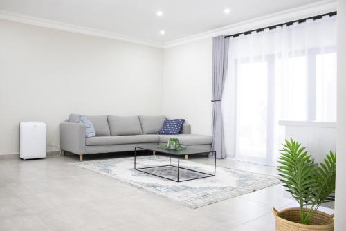 a living room with a couch and a table at Asania Guest House in Bloemfontein