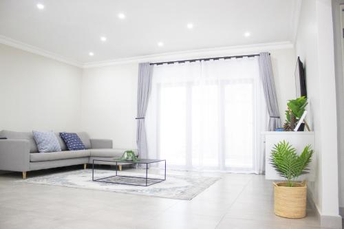 a living room with a couch and a table at Asania Guest House in Bloemfontein