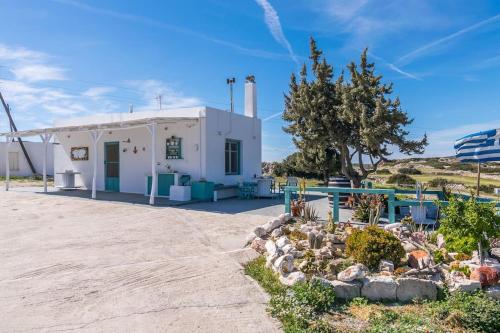 a white building with a garden in front of it at Gemilos Nest in Komia