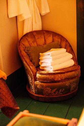 a stack of folded towels sitting on a chair at The George & Heart House in Kent