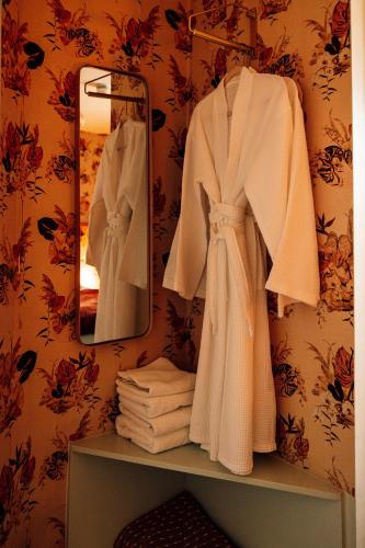 a white robe on a shelf in a bathroom at The George & Heart House in Kent