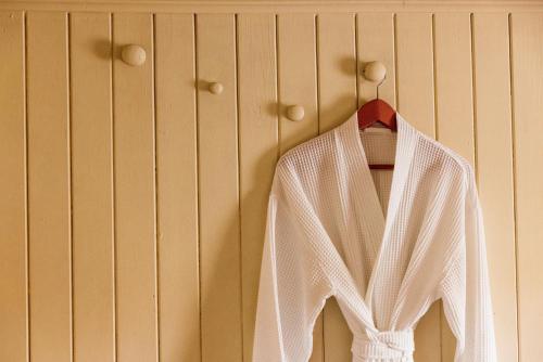 a white shirt is hanging on a wall at The George & Heart House in Kent