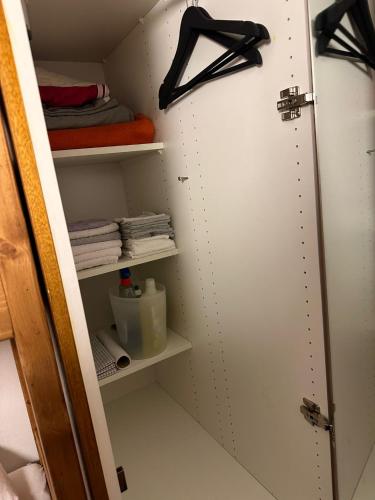 a closet with a door open with towels at Chambre Indépendante Valdor in Crans-Montana