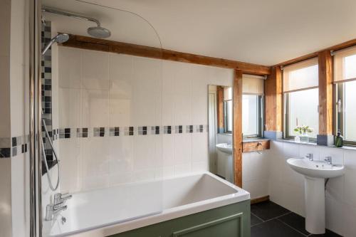 uma casa de banho com uma banheira e um lavatório em The Nook em Holbeton
