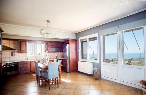 a kitchen with a table and chairs and a dining room at Irida's house in Kefallonia