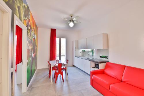 a living room with a red couch and a table at Rabbit Home in Misano Adriatico