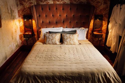 a bedroom with a large bed with pillows on it at The George & Heart House in Kent