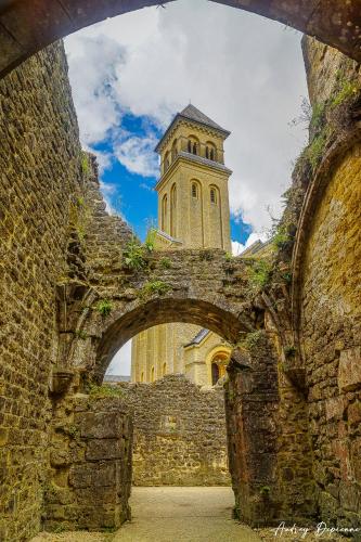 an old building with a clock tower in the background at Orval16 in Abbaye dʼOrval