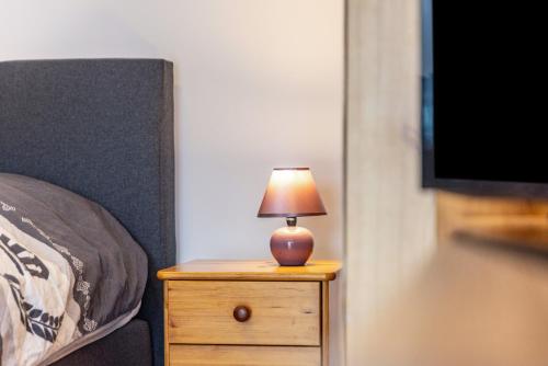 a lamp on a night stand next to a bed at Hohenzollern in Gammertingen