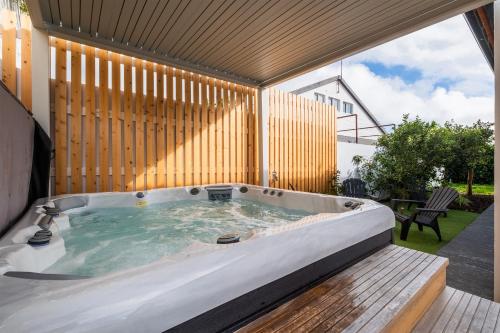 a jacuzzi tub in the backyard of a house at Azores Top House // Luxury and New House in Ponta Delgada