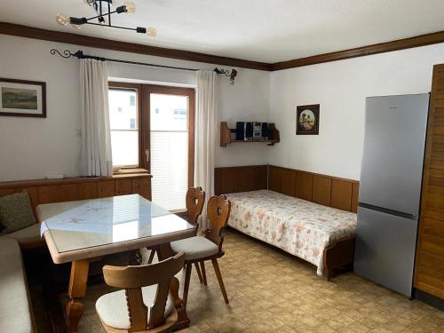 a kitchen with a table and a bed and a dining room at Haus Jochbergerstrasse 116 in Kitzbühel
