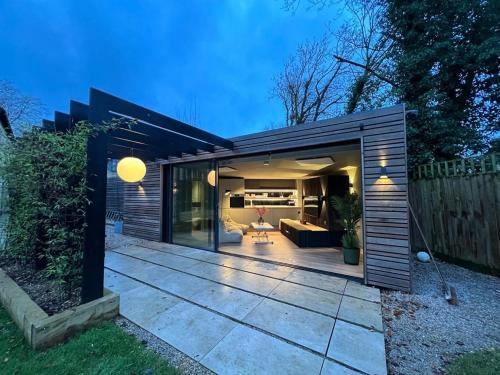 a small shed with a patio in a backyard at Contemporary Annex in Woodstock
