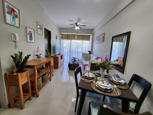 a dining room and living room with a table and chairs at Aloha Ocean Garden Villas Boracay in Boracay