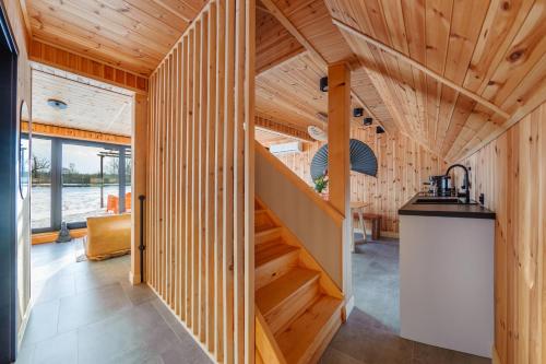 a staircase in a house with wooden walls at Zen Sasino in Sasino