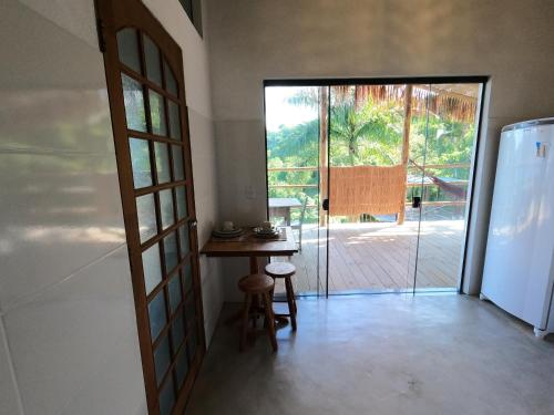 a room with a table and a sliding glass door at Villa Girassol in Ilhabela