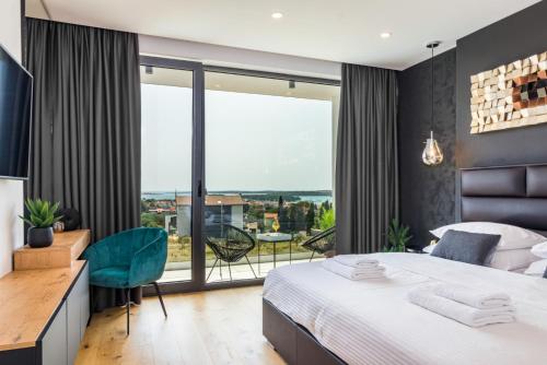 a bedroom with a bed and a large window at Luxury TABOO Villa & Spa in Medulin for 8 people with heated pool- wellness & sea view in Medulin