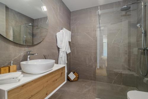 a bathroom with a sink and a shower at Luxury TABOO Villa & Spa in Medulin for 8 people with heated pool- wellness & sea view in Medulin