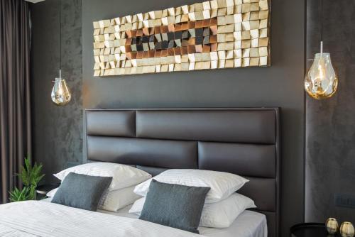 a bedroom with a bed with two pillows at Luxury TABOO Villa & Spa in Medulin for 8 people with heated pool- wellness & sea view in Medulin
