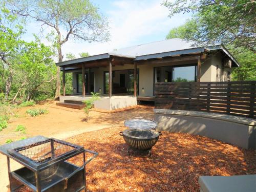 a small house with a grill in front of it at Wild Dog Guest Lodge in Hoedspruit