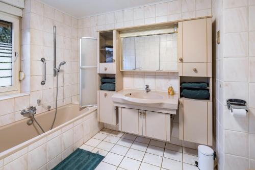 a bathroom with a sink and a shower and a tub at Traumschmiede in Bad Emstal