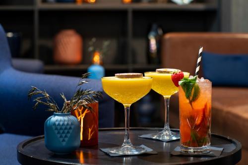 three cocktails on a tray on a table at Bilderberg Europa Hotel Scheveningen in Scheveningen