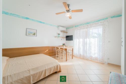 A bed or beds in a room at Residence Baia di Norsi