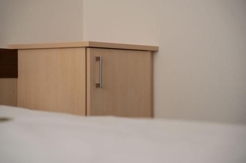 a wooden cabinet with a door in a room at Frühstückspension Auer - Haus Kargl in Schladming