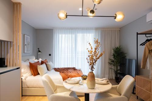uma sala de estar com um sofá e uma mesa em Icon Apartments by NÔMA em Porto