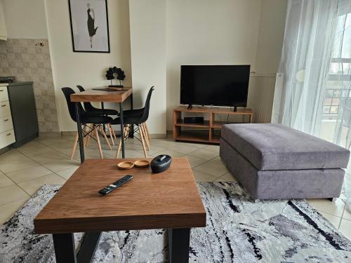 a living room with a coffee table and a couch at Syggrou Open View Apt in Thessaloniki