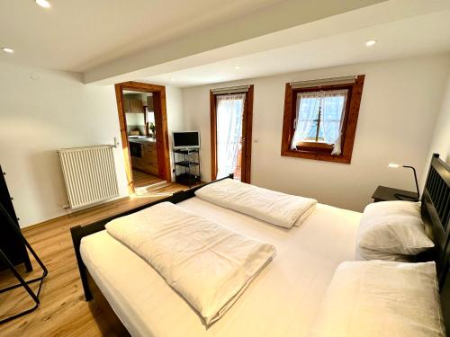 a large bedroom with two beds and a television at Ferienwohnungen Roderer in Berchtesgaden