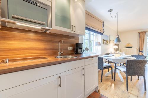 a kitchen with a sink and a table at Suederhof 6 in Keitum