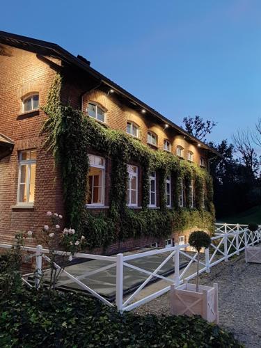 a building with ivy growing on the side of it at Tenuta Castello in Cerrione