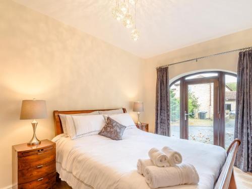a bedroom with a bed with towels on it at 2 bed property in Hamsterley 80003 in High Etherley