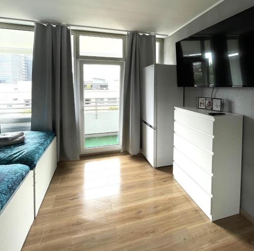 a small kitchen with a refrigerator and a window at Apartment in Neuss. 4 Personen in Neuss