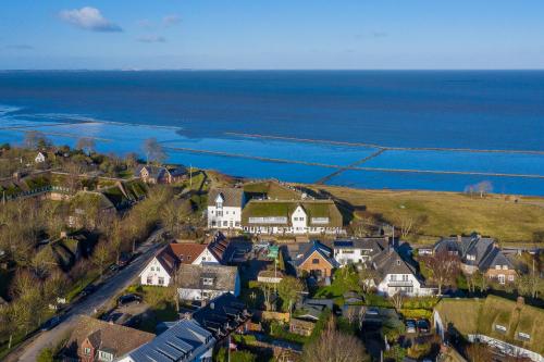 an aerial view of a house with the ocean in the background at Blue Haven in Keitum