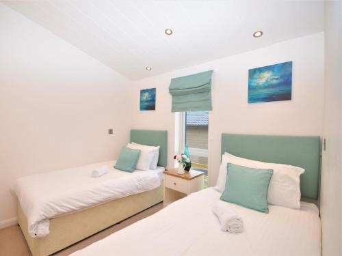 a bedroom with two beds and a window at 2 Bed in South Molton 82260 in Romansleigh