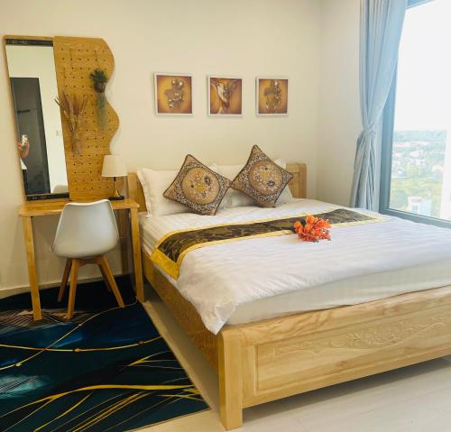 a bedroom with a bed with a mirror and a window at Căn hộ studio Vinhome grand park Quận 9 in Long Bình