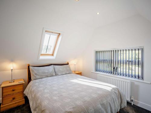 a white bedroom with a bed and a window at 3 bed in Hamsterley 81503 in Evenwood