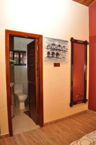 an open door to a bathroom with a toilet at Santa Monica Home Lodge in Senchi