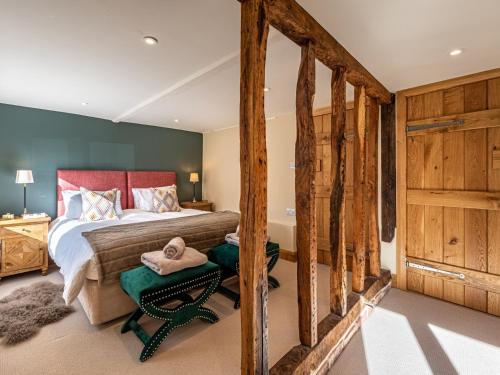 a bedroom with a bed and wooden walls at 3 Bed in Madley 83659 in Madley