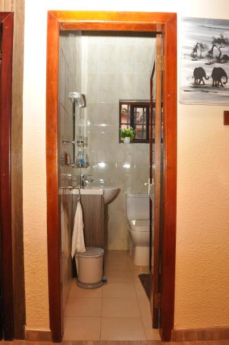 a bathroom with a toilet and a sink at Santa Monica Home Lodge in Senchi