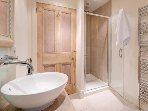 a bathroom with a white sink and a shower at 2 Bed in Cartmel 83546 in Cartmel