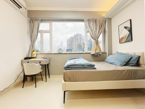 a bedroom with a bed and a desk and a window at Student Accommodation - 5 Man Cheong Street in Hong Kong
