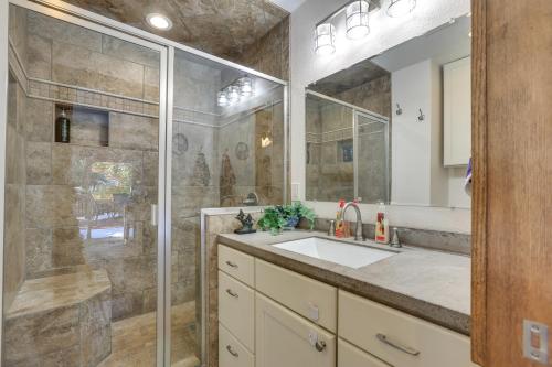 een badkamer met een wastafel en een glazen douche bij Lakewood Gem with Deck about 7 Mi to Downtown Denver in Lakewood